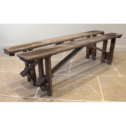 831 - A near pair of pine benches, early 20th century, of rectangular form upon fixed trestle type support... 