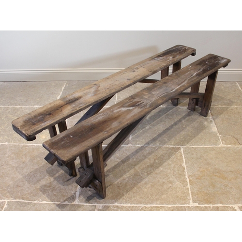 831 - A near pair of pine benches, early 20th century, of rectangular form upon fixed trestle type support... 