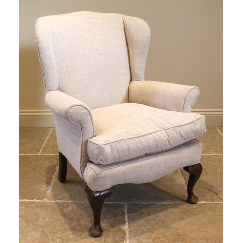 838 - A George III style wing back armchair, early 20th century, of cottage proportions, with padded wing ... 