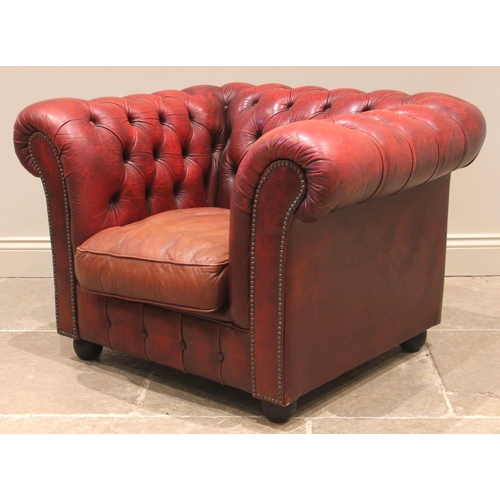 856 - A red leather Chesterfield sofa, late 20th century, of deep set button back form, enclosing three lo... 