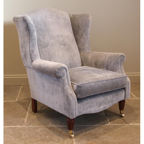 859 - A Laura Ashley Georgian style wingback armchair, in grey velour, the padded wing backs and scroll ar... 