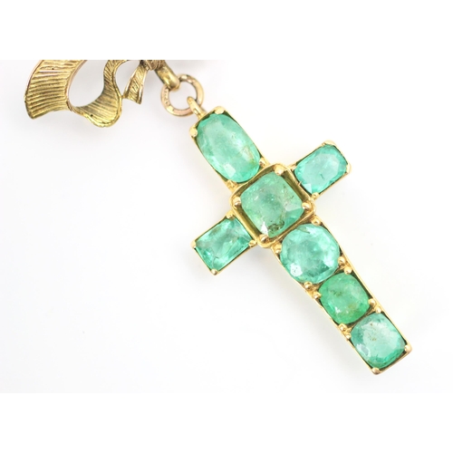 90 - A 20th century emerald set cross pendant/brooch, the mixed cut emeralds within yellow metal claw set... 