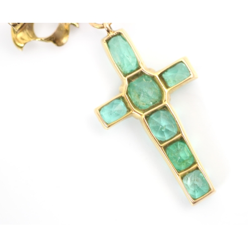 90 - A 20th century emerald set cross pendant/brooch, the mixed cut emeralds within yellow metal claw set... 