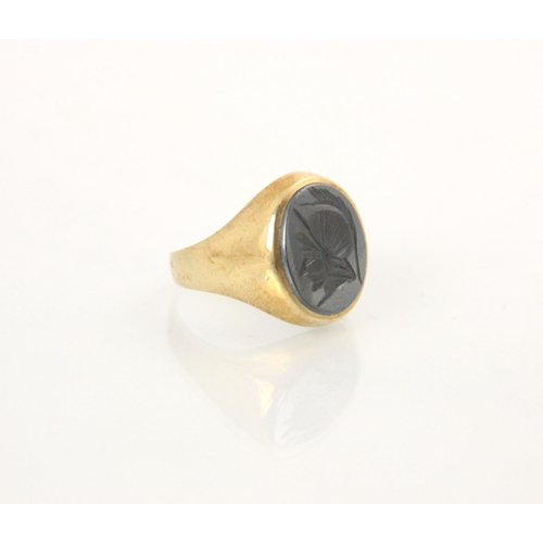 96 - A 9ct yellow gold signet ring, the carved intaglio head depicting a Roman warrior, stamped London 19... 