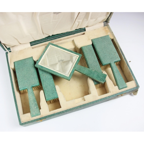 183 - A Wallace Allan cased dressing table set, comprising two clothes brushes, two hair brushes and handh... 