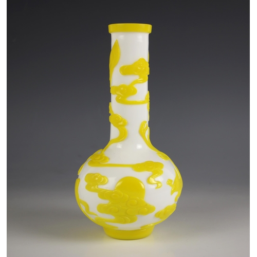 574 - A Chinese Peking glass bottle vase, 20th century, the white opaline body decorated with yellow overl... 