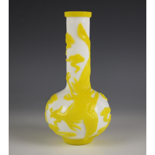 574 - A Chinese Peking glass bottle vase, 20th century, the white opaline body decorated with yellow overl... 