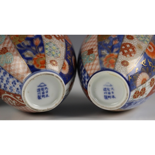 575 - A pair of Japanese Imari porcelain vases, Meiji period (1868-1912), each of ovoid form and decorated... 