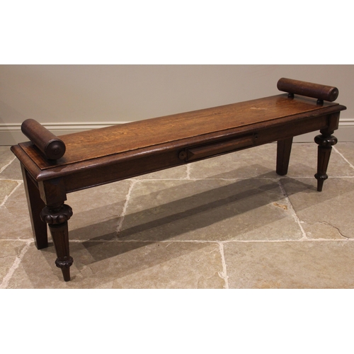 805 - A Victorian oak window seat, the rectangular moulded top applied with cylinder handles to each end, ... 