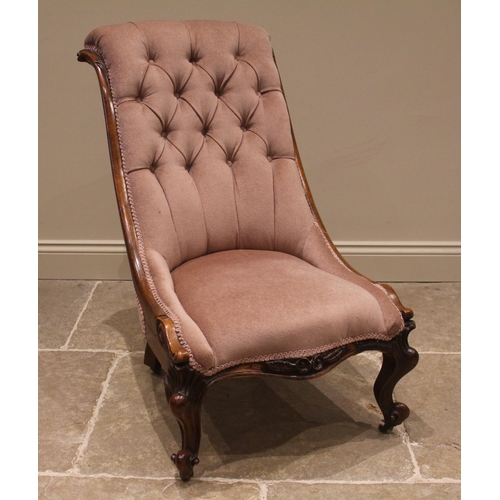 815 - A Victorian mahogany framed salon chair, the button back within a swept and scrolled frame, over the... 