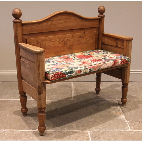 816 - A pine hall bench, the arched panelled back above a solid seat, upon tapering legs and peg feet, 96c... 