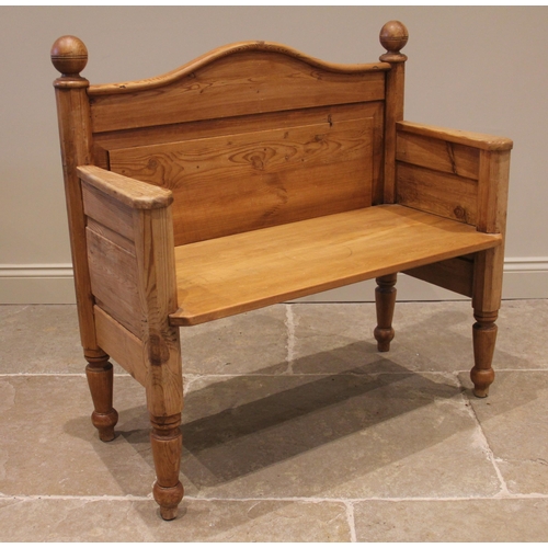 816 - A pine hall bench, the arched panelled back above a solid seat, upon tapering legs and peg feet, 96c... 