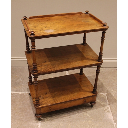 821 - A mid-19th century figured walnut etagere, the three quarter galleried tray top upon ring turned sup... 