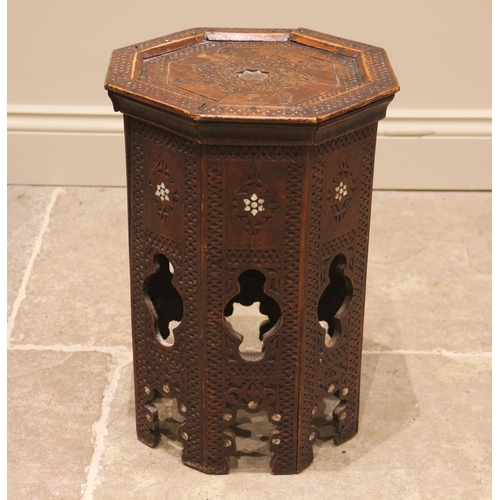 822 - An Anglo-Indian octagonal hardwood occasional table, carved with geometric detail, inlaid with mothe... 