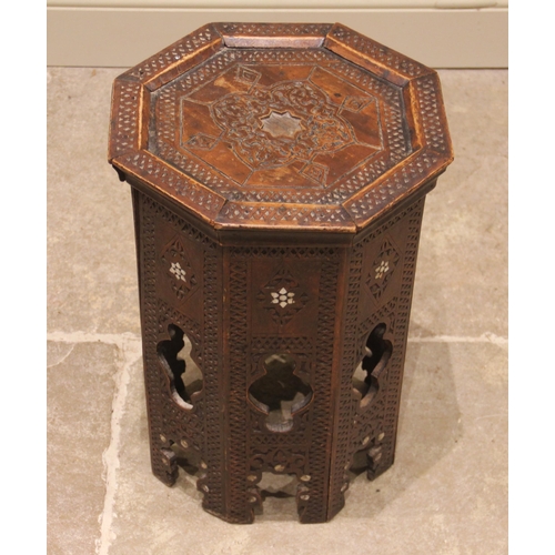 822 - An Anglo-Indian octagonal hardwood occasional table, carved with geometric detail, inlaid with mothe... 