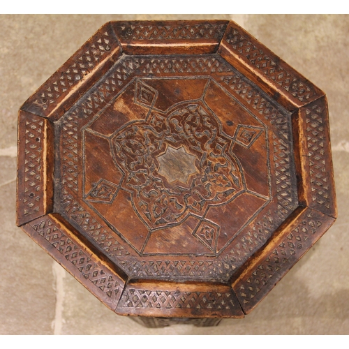 822 - An Anglo-Indian octagonal hardwood occasional table, carved with geometric detail, inlaid with mothe... 