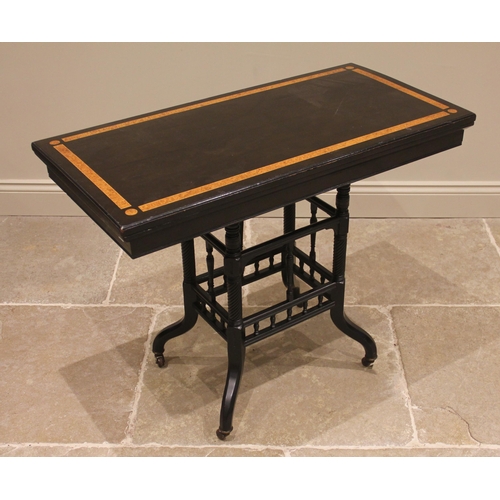 823 - A Victorian ebonised and amboyna card table, the hinged top inlaid with amboyna banding punctuated b... 