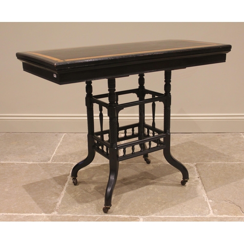 823 - A Victorian ebonised and amboyna card table, the hinged top inlaid with amboyna banding punctuated b... 