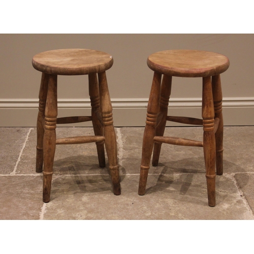 839 - A pair of beech Boston stools, early 20th century, the lightly dished circular seats upon ring turne... 