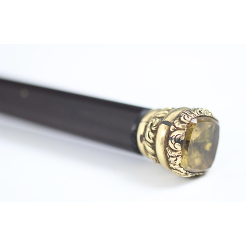 181 - A mid-19th century citrine topped cane, with yellow metal mount and tapered cylindrical lacquered wo... 