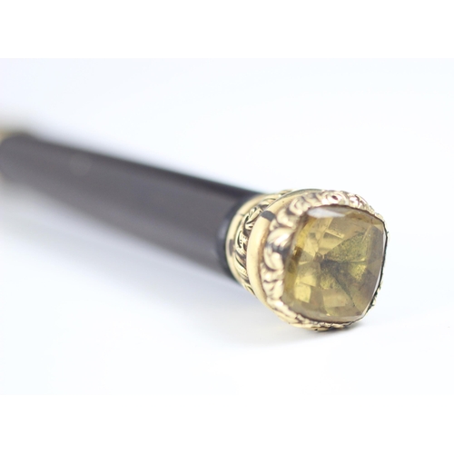 181 - A mid-19th century citrine topped cane, with yellow metal mount and tapered cylindrical lacquered wo... 