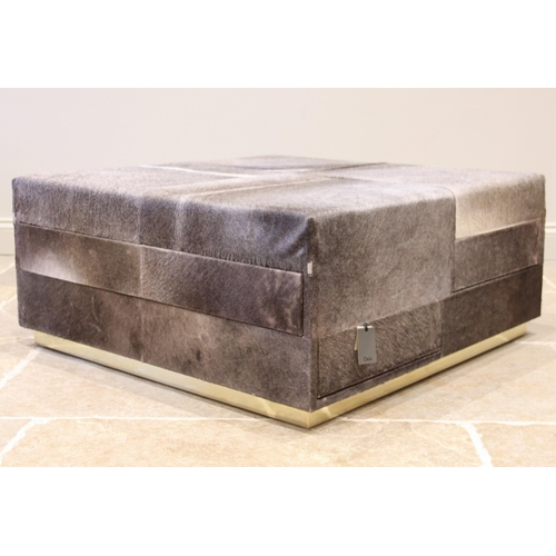 848 - An Oka Locke cow hide ottoman, of cubic form with padded seats above six suede lined drawers, upon a... 