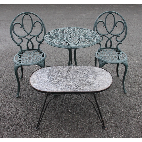 863 - A modern painted cast metal tete a tete patio set, comprising a circular table, 70.5cm high, 62cm di... 