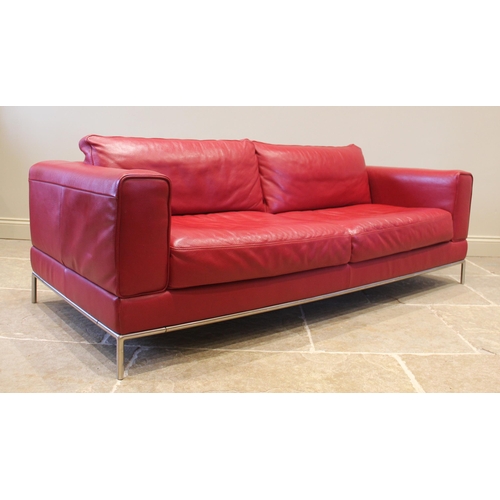 857 - An Italian style contemporary red leather sofa, of angular deep set form, with fixed rear cushions, ... 