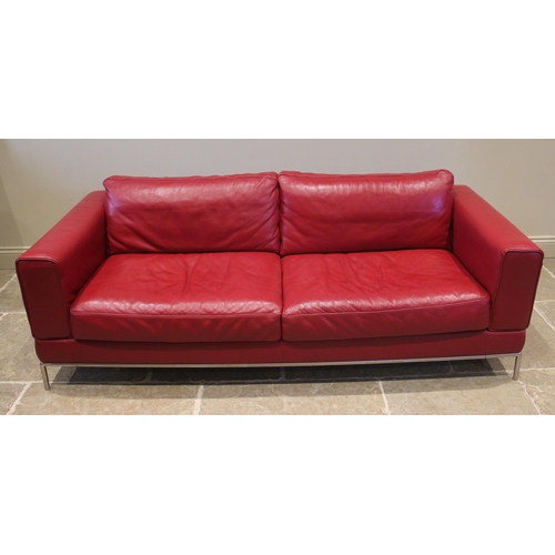 857 - An Italian style contemporary red leather sofa, of angular deep set form, with fixed rear cushions, ... 