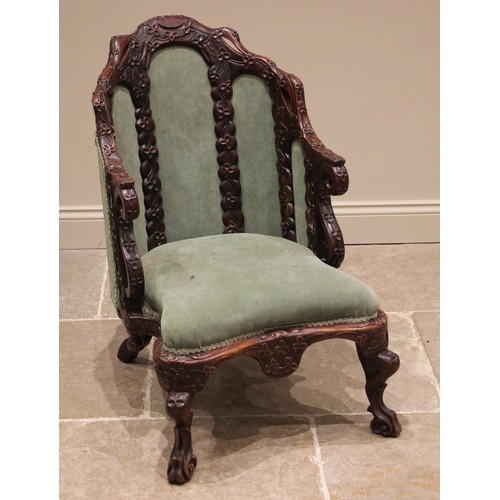 810A - A Ceylonese carved wood and upholstered armchair, 19th century, the arched frame profusely carved wi... 