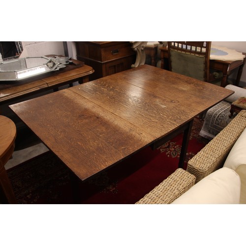 804 - A 19th century oak drop leaf table, the rectangular top upon legs of tapering square section, 70cm H... 