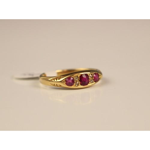 132 - An Edwardian untested ruby and diamond ring, the central  cushion cut red stone with a smaller round... 