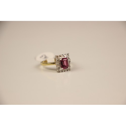 163 - An 18ct yellow gold untested almandine garnet and diamond cluster ring, the emerald cut red stone wi... 