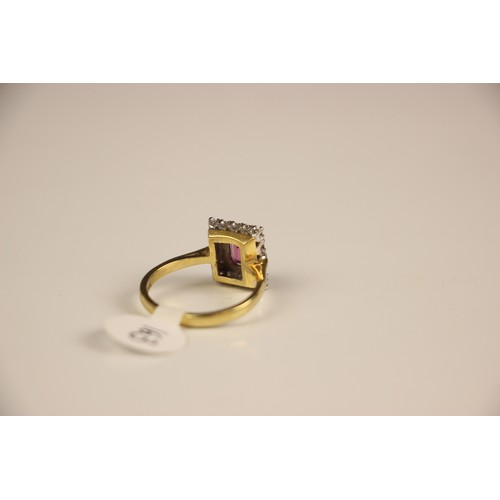 163 - An 18ct yellow gold untested almandine garnet and diamond cluster ring, the emerald cut red stone wi... 