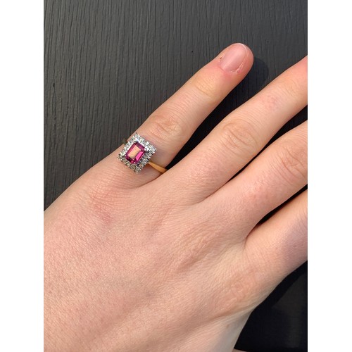 163 - An 18ct yellow gold untested almandine garnet and diamond cluster ring, the emerald cut red stone wi... 