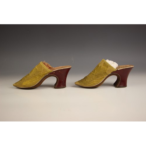 353 - A fine and rare pair of canary yellow silk damask ladies mules, English circa 1720, the vamps with m... 
