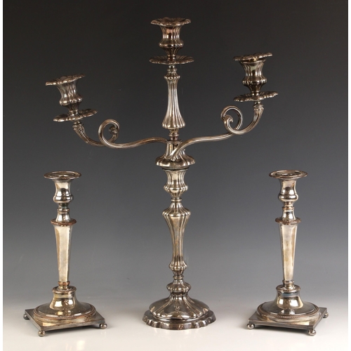 106 - An Elkington & Co silver plated three branch candelabra, the three urn shaped sconces above conformi... 