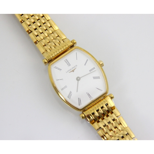 125 - A gold plated ladies Longines wrist watch, the shaped white dial with Roman numerals, set to a plain... 