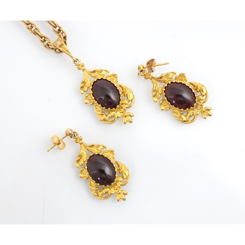 142 - A suite of untested garnet jewellery, comprising pair of earrings and pendant, the cabochon red ston... 