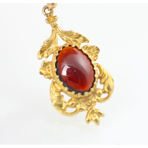 142 - A suite of untested garnet jewellery, comprising pair of earrings and pendant, the cabochon red ston... 