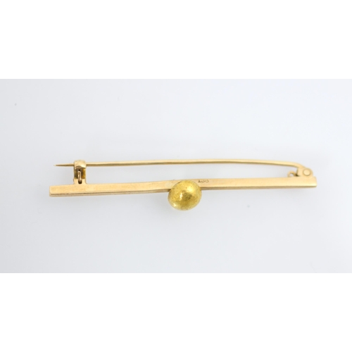 147 - A yellow metal bar brooch, the plain polished bar brooch with applied 'gold nugget', hinge pin to re... 