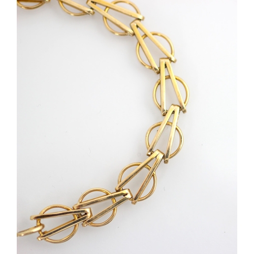 148 - A 9ct yellow gold bracelet, the circular links with arrow head shaped detail to centre, stamped '9.3... 