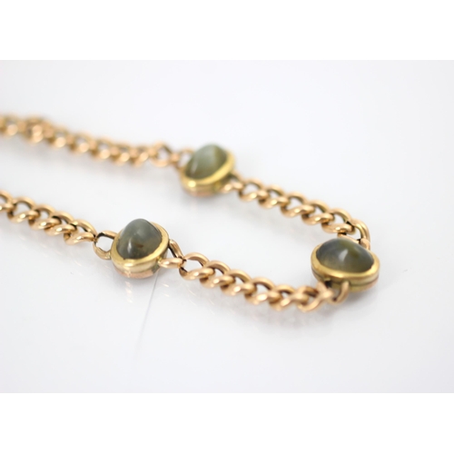 149 - An early 20th century yellow metal bracelet, the curb link bracelet later set with three cabochon ch... 