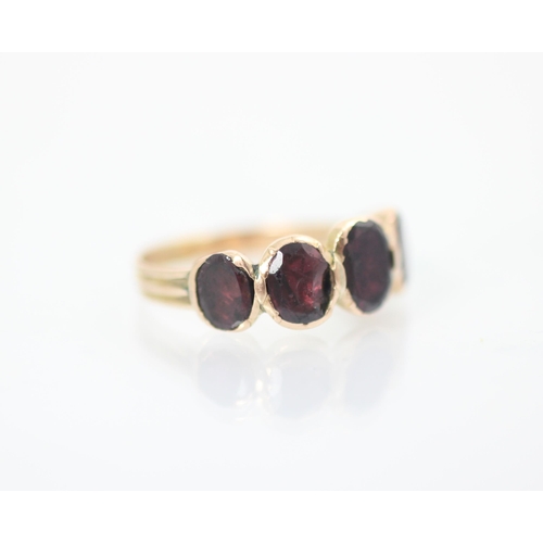 153 - A late 19th/20th century garnet five stone ring, the five oval cut stones, closed to reverse (possib... 