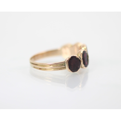 153 - A late 19th/20th century garnet five stone ring, the five oval cut stones, closed to reverse (possib... 