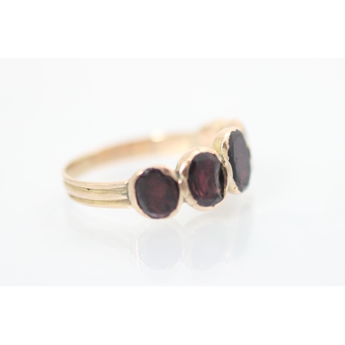 153 - A late 19th/20th century garnet five stone ring, the five oval cut stones, closed to reverse (possib... 