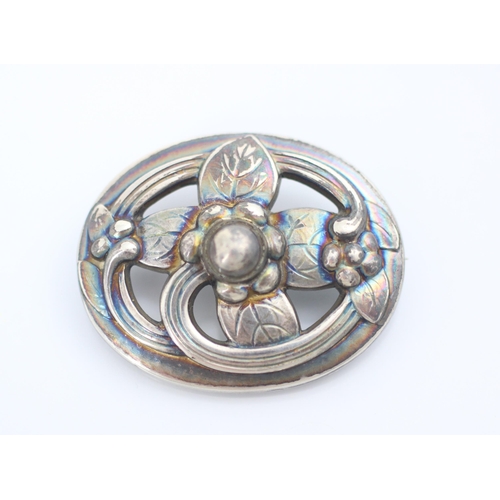 157 - A Georg Jensen silver brooch, the oval openwork brooch with engraved leaf and stylised flower head d... 