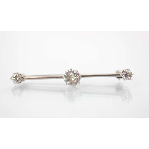 160 - A 20th century diamond set bar brooch, the central old cut diamond within white metal claw set setti... 