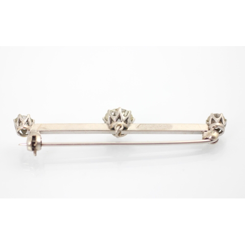 160 - A 20th century diamond set bar brooch, the central old cut diamond within white metal claw set setti... 