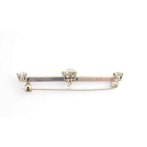 160 - A 20th century diamond set bar brooch, the central old cut diamond within white metal claw set setti... 